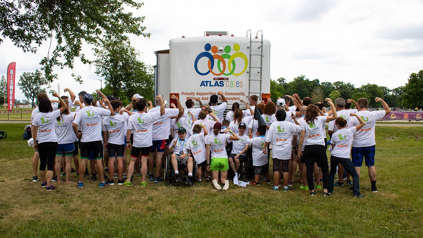 The Atlas Cares and Team Joseph teams pose after completing the Motor City Triathlon.